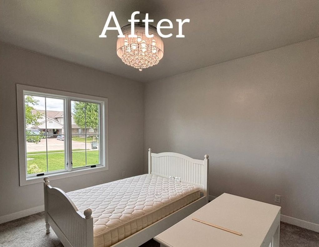 Bedroom with pink walls, white bed, and window. - after