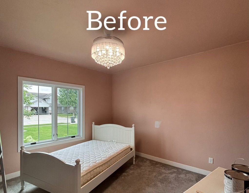 Bedroom with pink walls, white bed, and window. - before