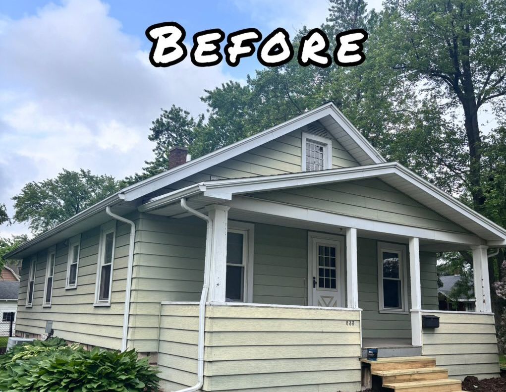 A light green house with white trim and a porch. - before