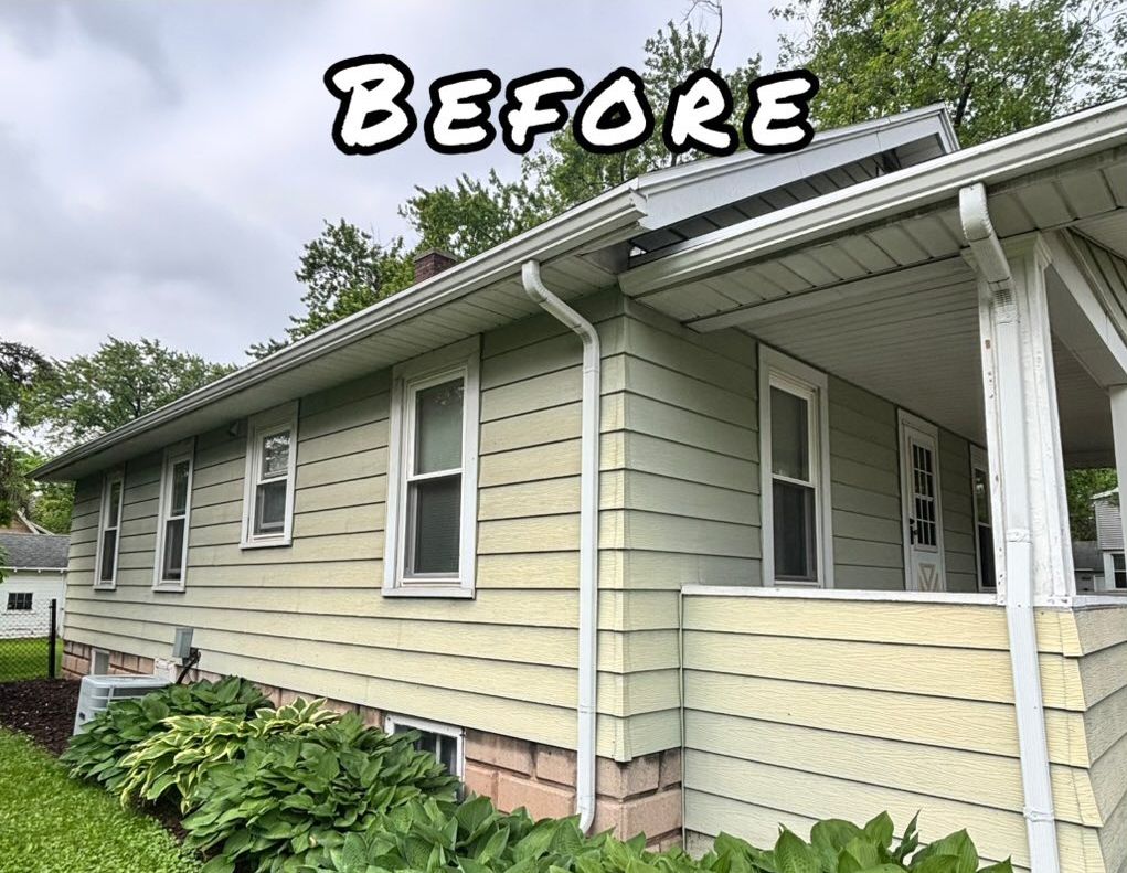 A photo of a yellow house with white trim, gutters, and windows. - before