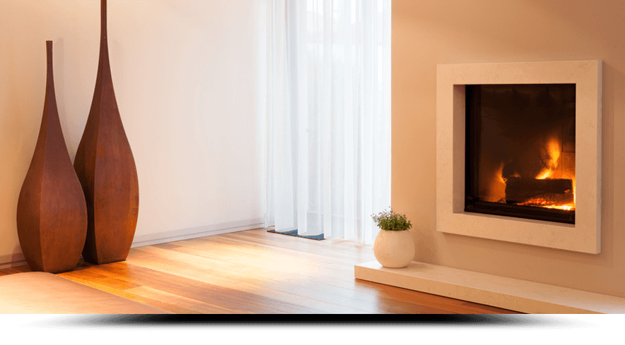 A living room with a fireplace and two vases on the wall.