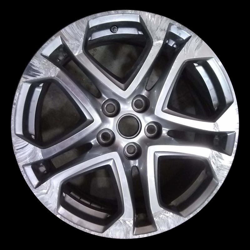 A close up of a car wheel on a black background