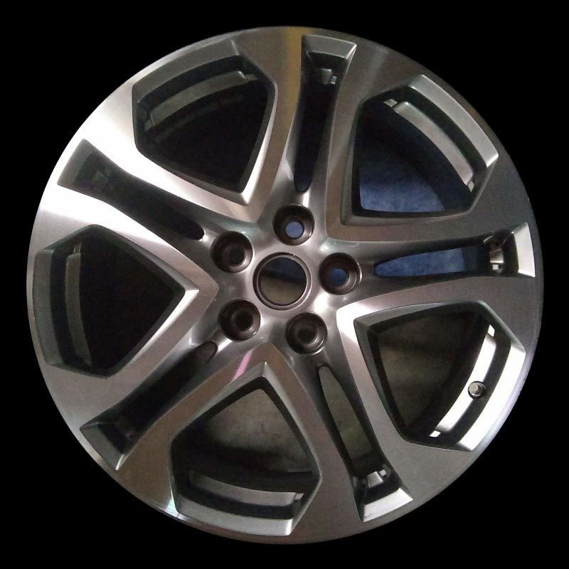 A close up of a car wheel on a black background