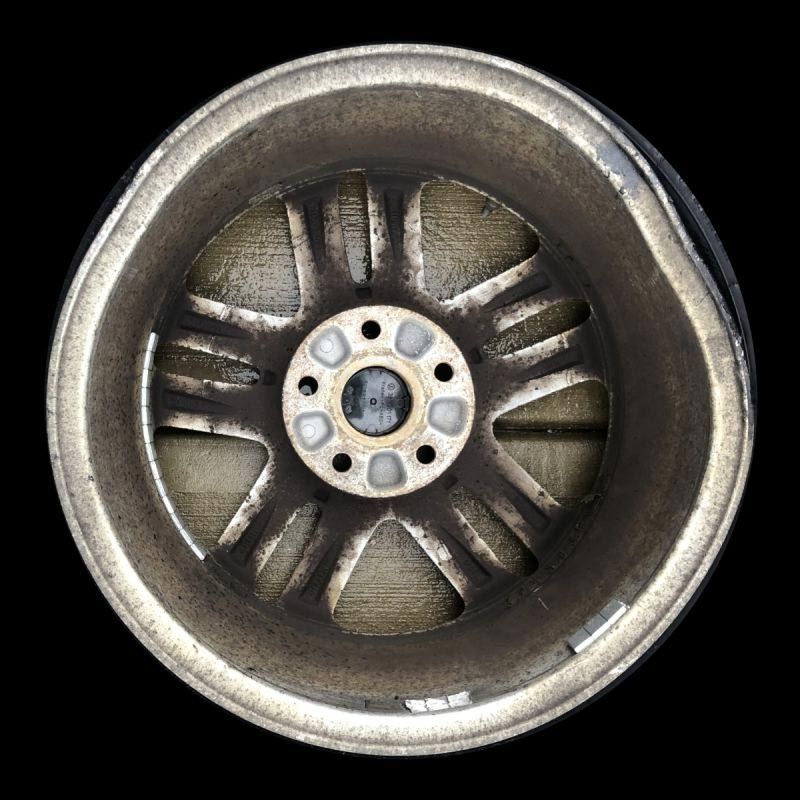 A close up of a car wheel on a black background