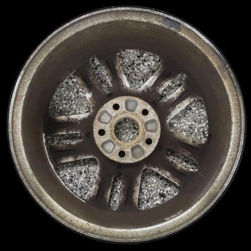 A close up of a car wheel with a black background