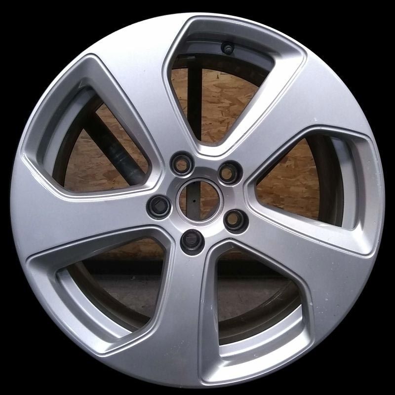 A close up of a silver wheel on a black background