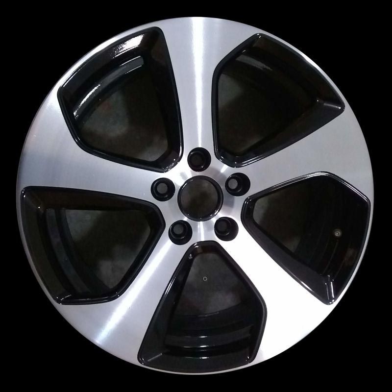 A close up of a black and silver wheel on a black background