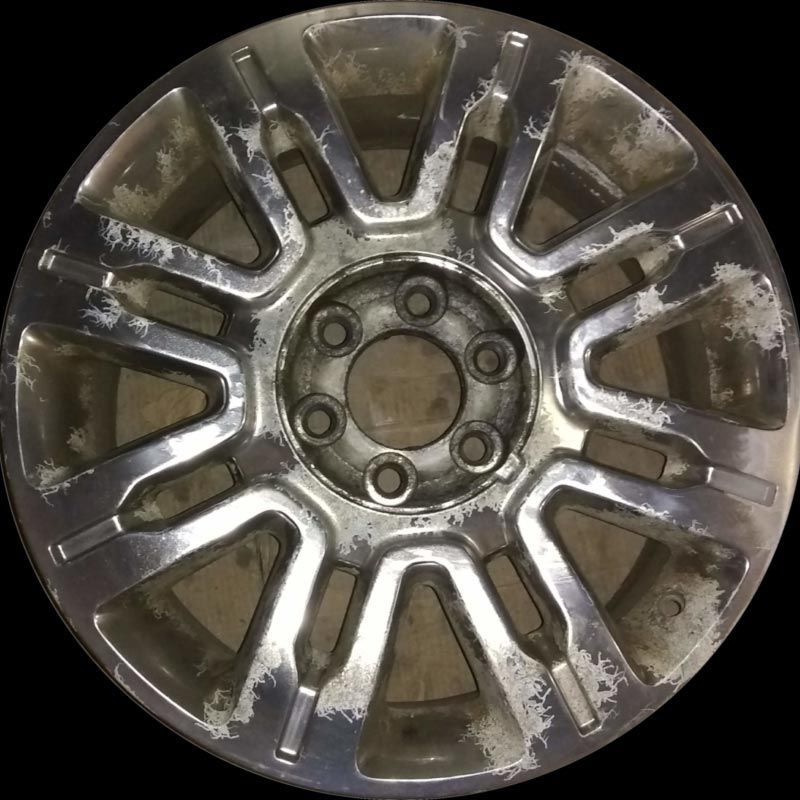 A close up of a car wheel with a black background