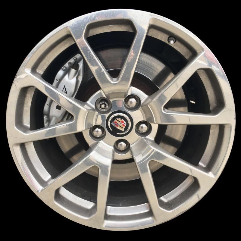 A close up of a car wheel on a black background