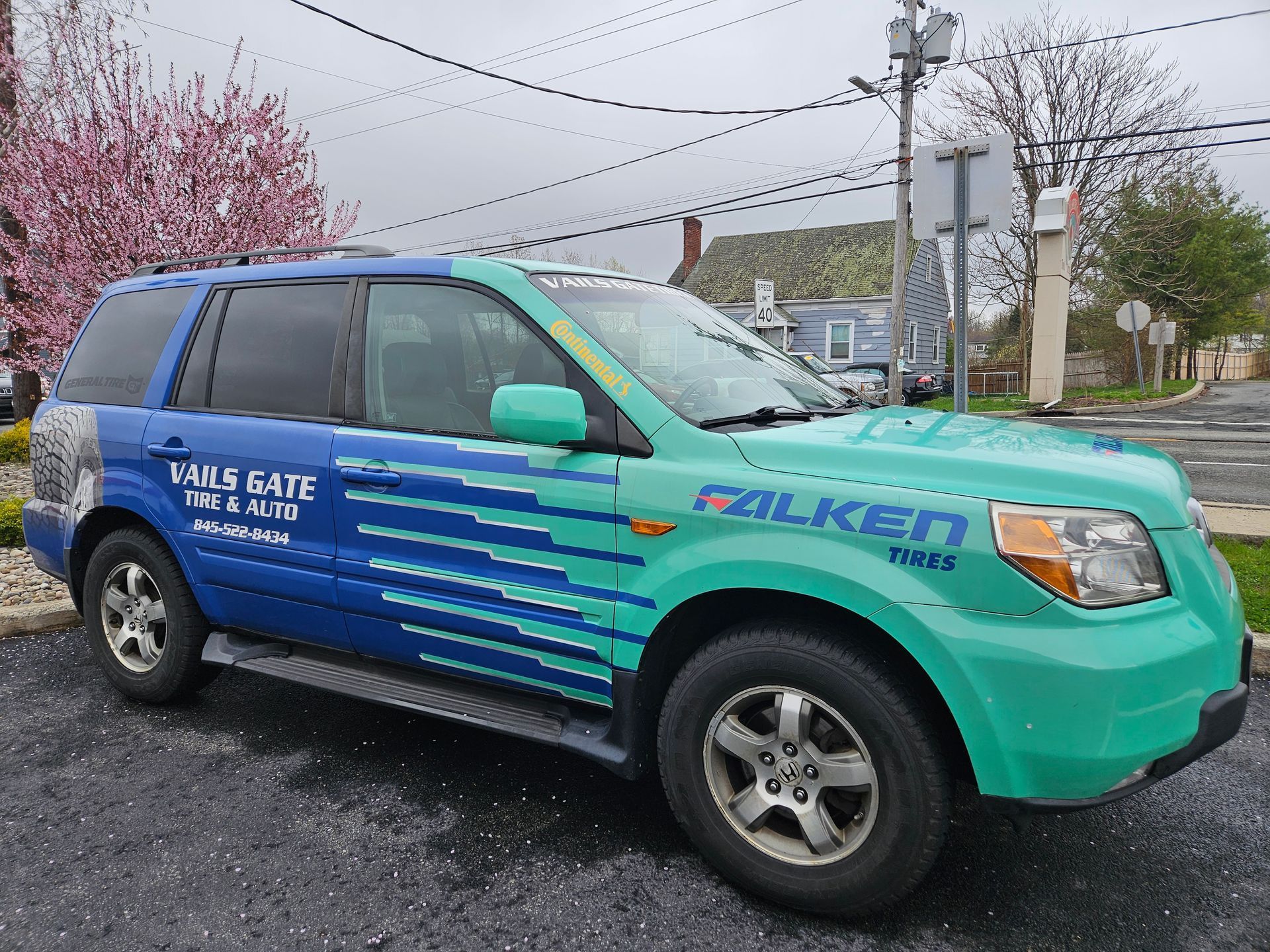 A blue and green suv company vehicle for Vails Gate Tires and Auto