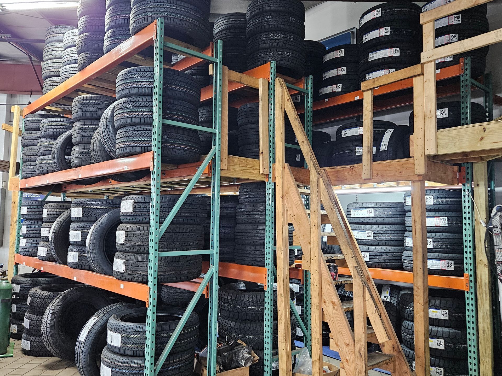 A warehouse filled with lots of tires on shelves