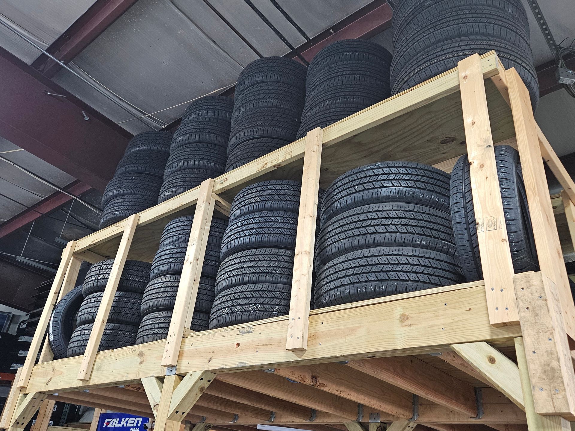 A stack of tires sitting on top of a wooden shelf