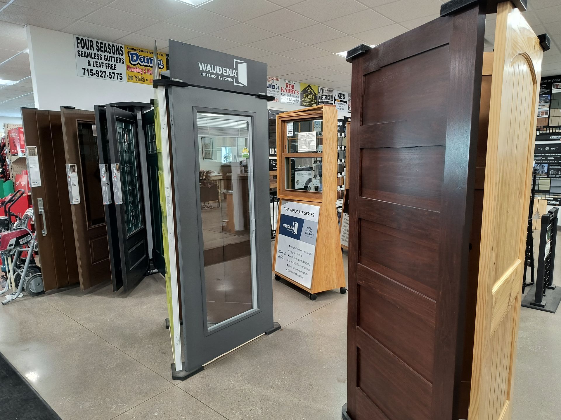Doors on display in a store, various styles and colors.