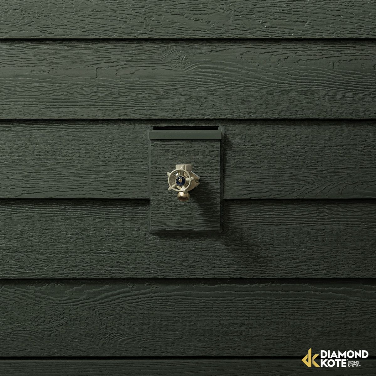 Dark green wooden siding with a small metal wall-mounted fixture centered on it