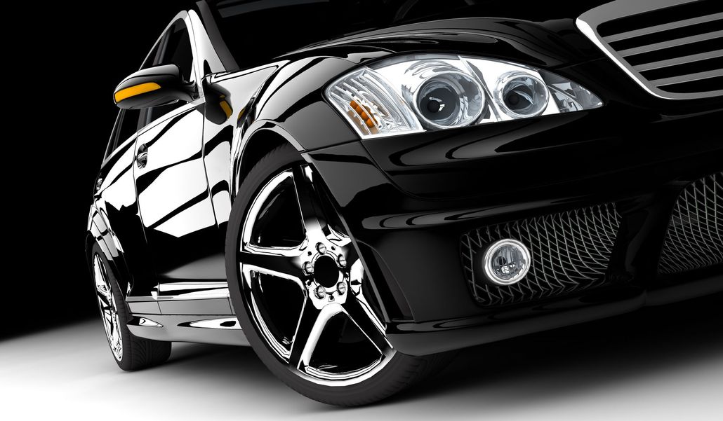 Black luxury car with shiny chrome rims and headlights.