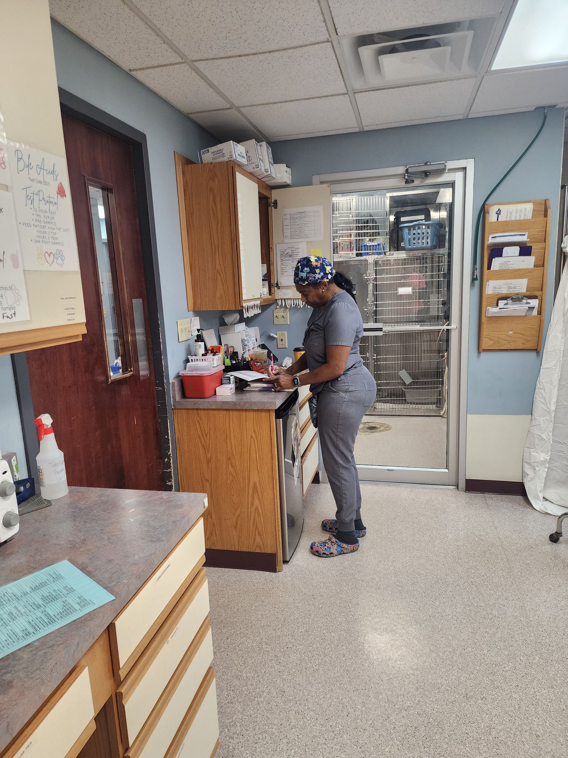 A woman in scrubs is working in a kitchen
