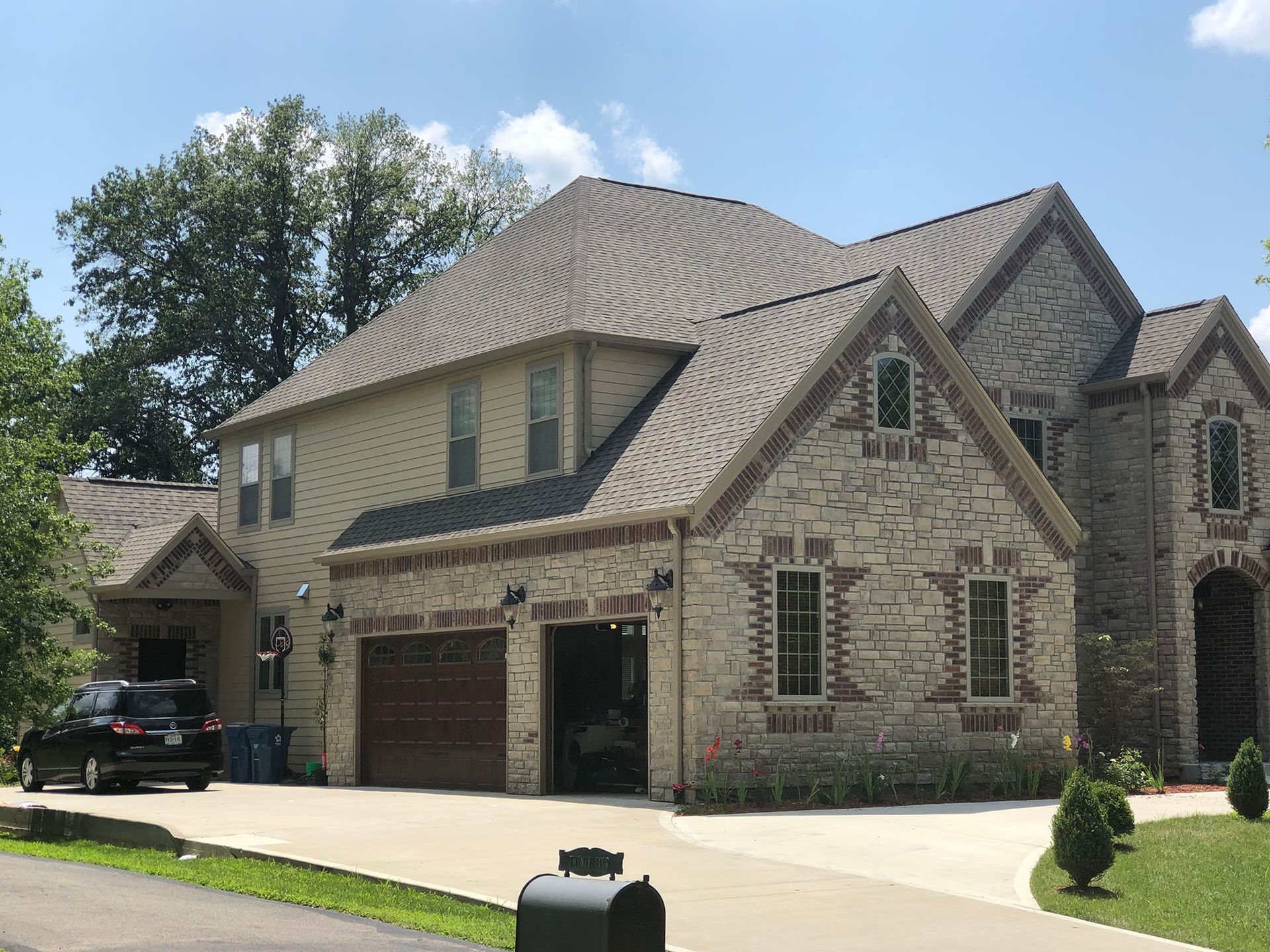 A large brick house with a mailbox in front of it.