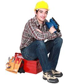 Smiling Handyman sitting on toolbox