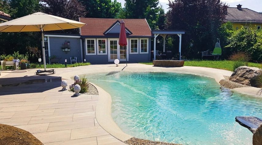 A house with a swimming pool in front of it