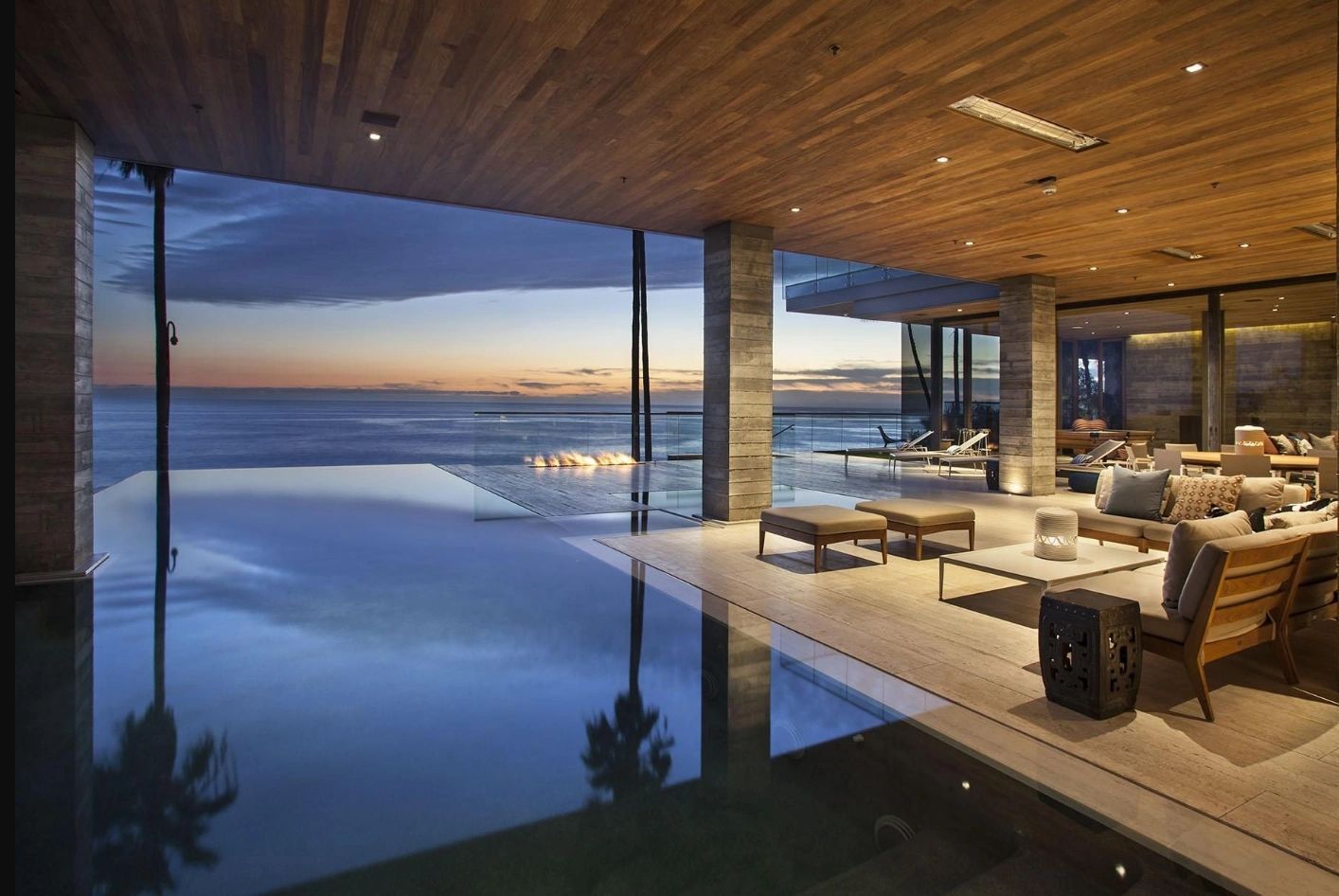 A large house with a swimming pool and a view of the ocean.