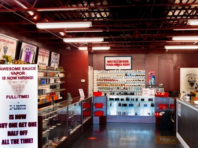 A store with a sign that says awesome sauce vapor is now hiring