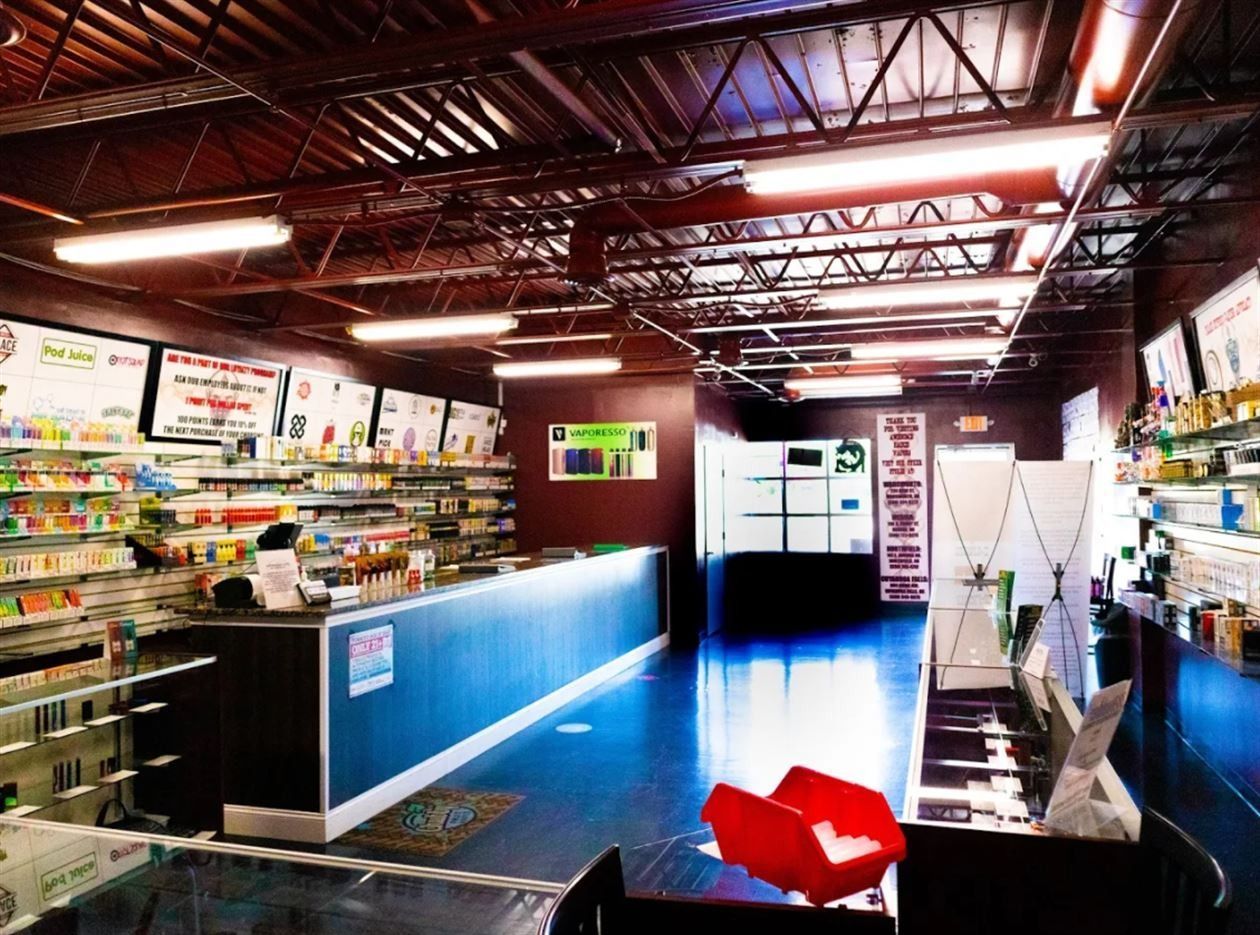 The inside of a store with lots of shelves and a counter