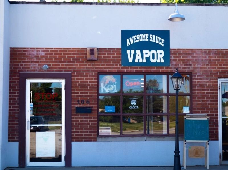 A brick building with a sign that says awesome sauce vapor