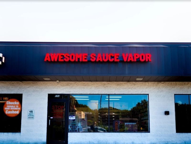 A store front with a sign that says awesome sauce vapor