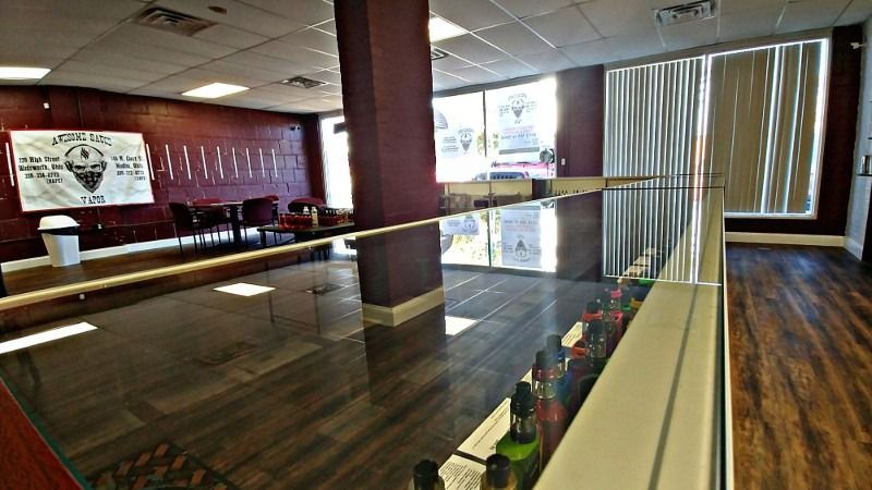 A large room with hardwood floors and a glass railing.