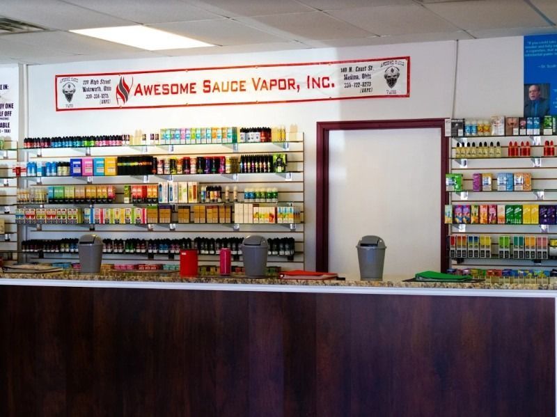 A store called awesome sauce vapor inc. has lots of products on shelves
