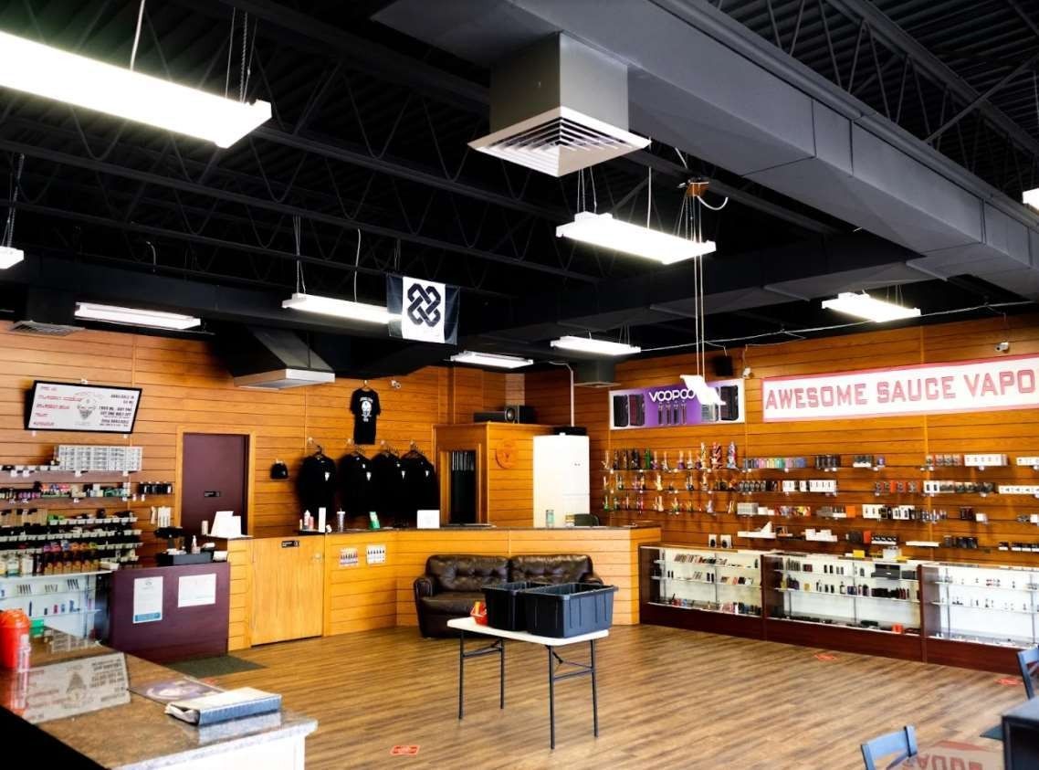 An empty store with a sign that says sauce vapor