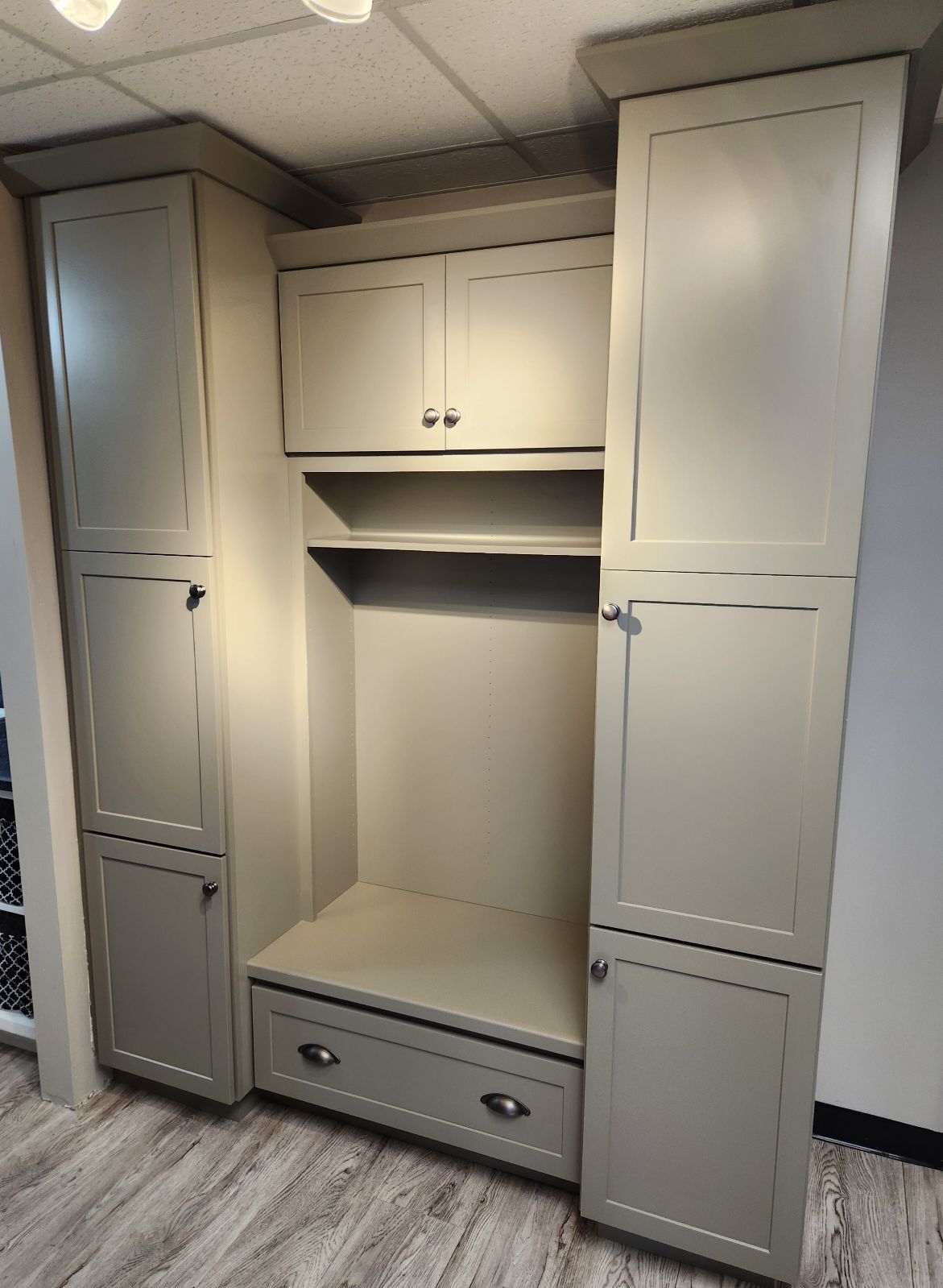 A room with a lot of cabinets and drawers in it.