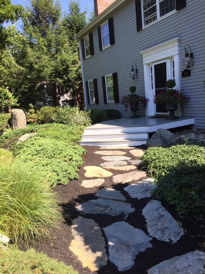 A stone walkway leading to the front door of a house