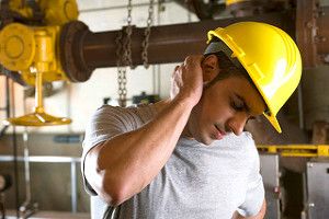 An employee feeling the back of his head