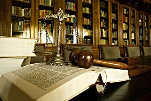 Decorative scale of justice in the library, sitting on an open book