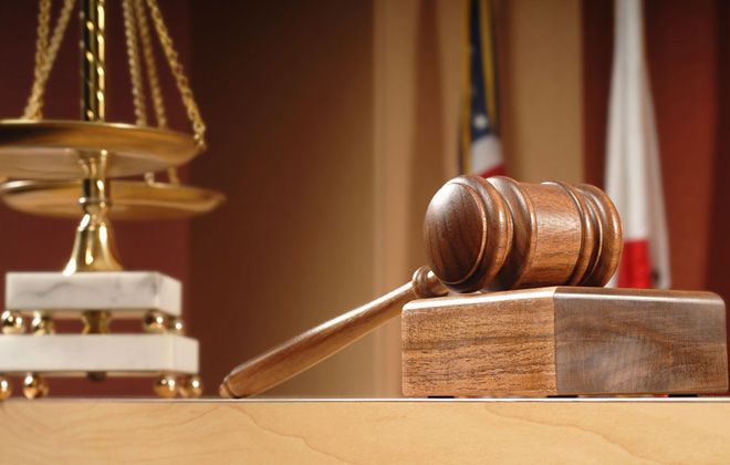 Gavel and scale of justice on top of the table in a courtroom