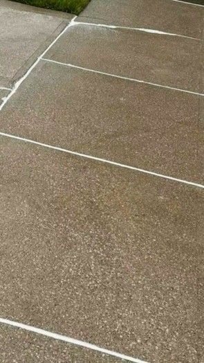 Brown concrete sidewalk with white lines dividing sections.