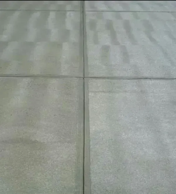 Gray concrete tiles with dark grout lines.