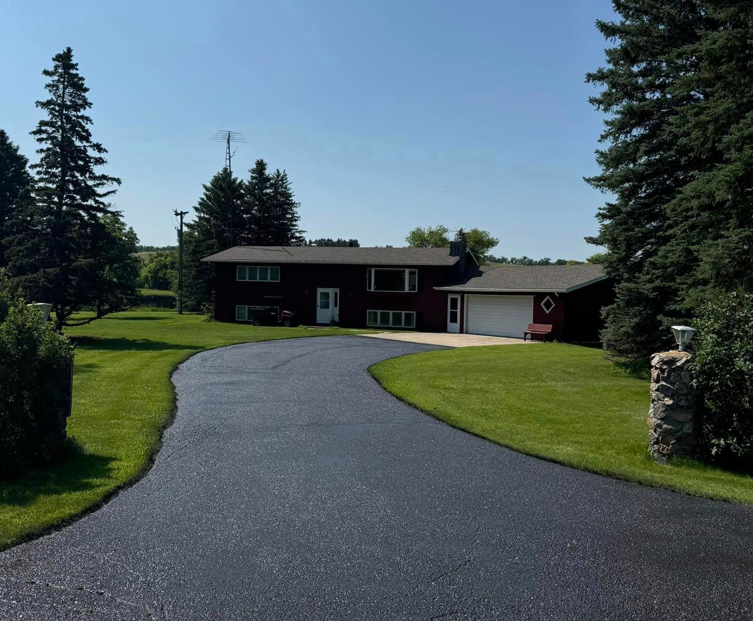 A house with a large driveway leading to it