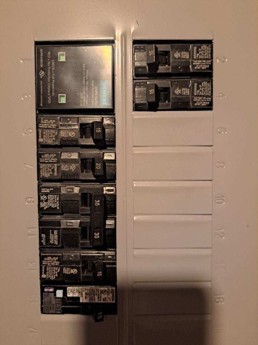 Electrical breaker panel, partially open, with switches in the on and off positions.