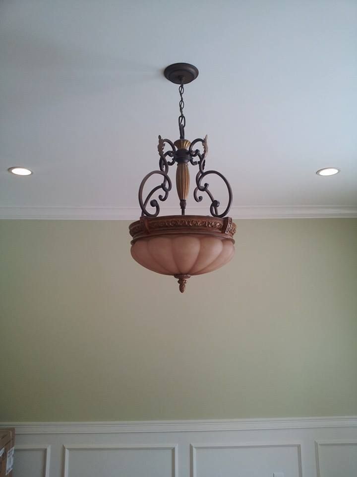 A chandelier is hanging from the ceiling in a room