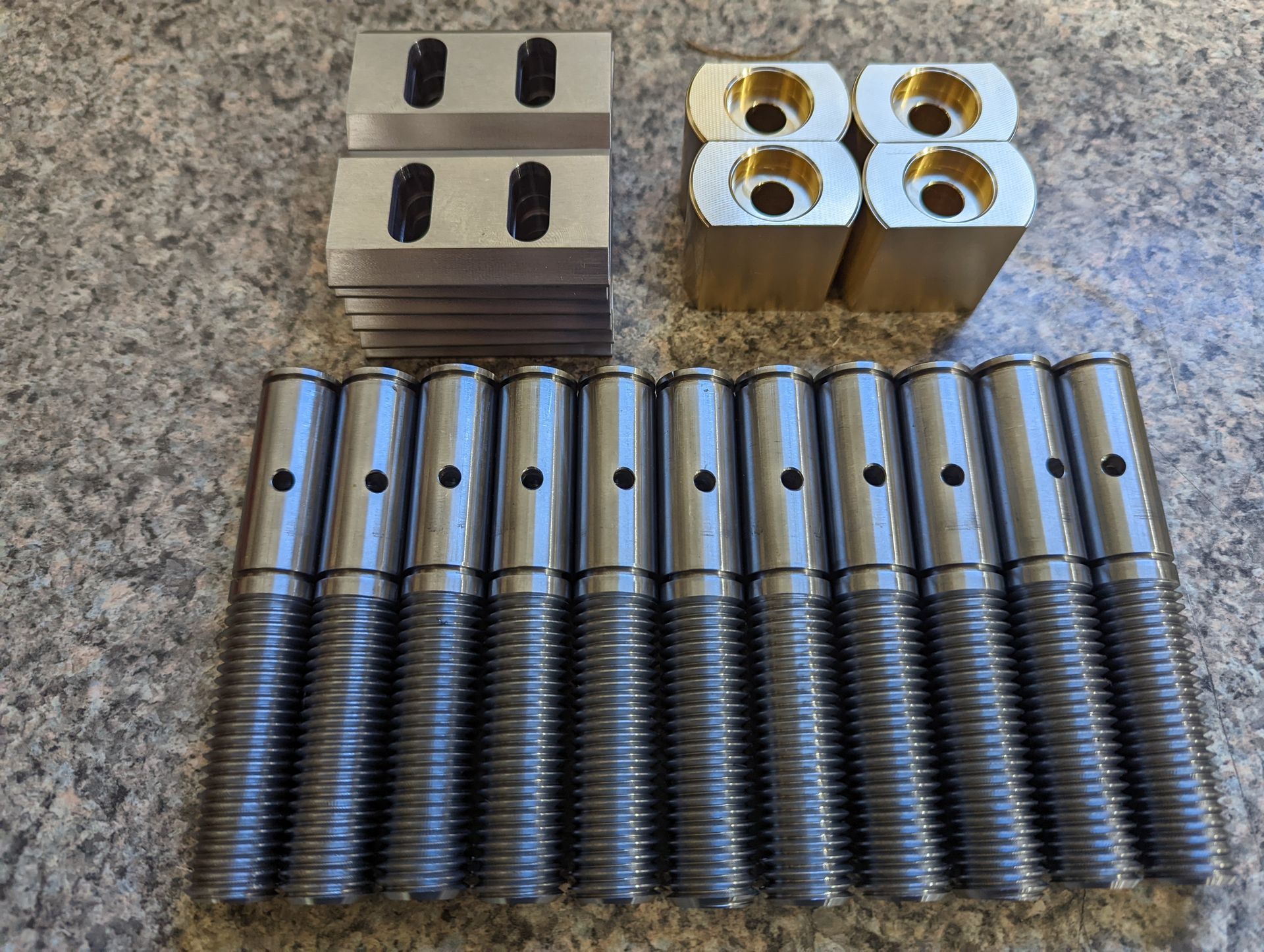 A bunch of metal parts are sitting on a table.