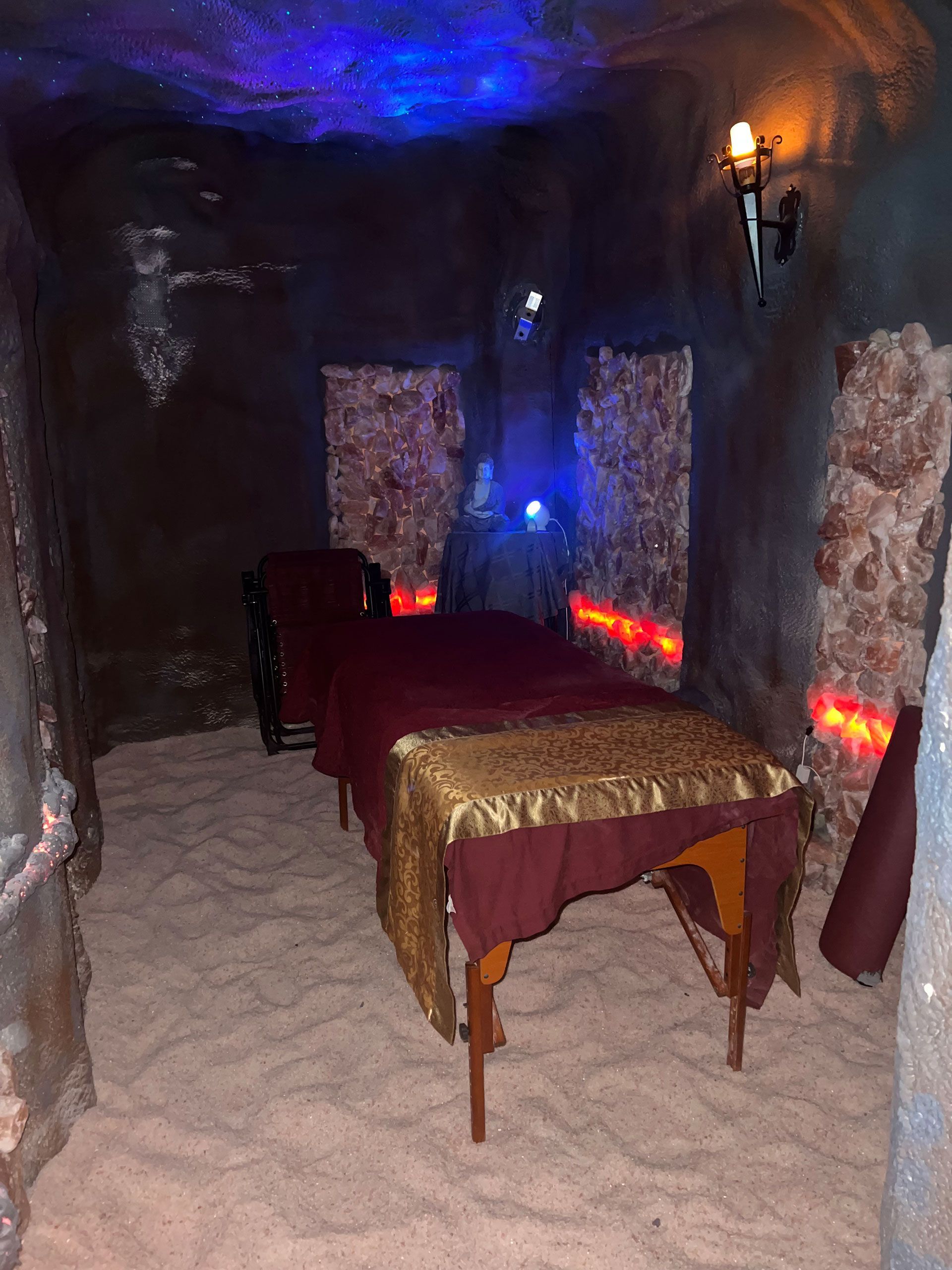 a massage table in the middle of a cave-like room