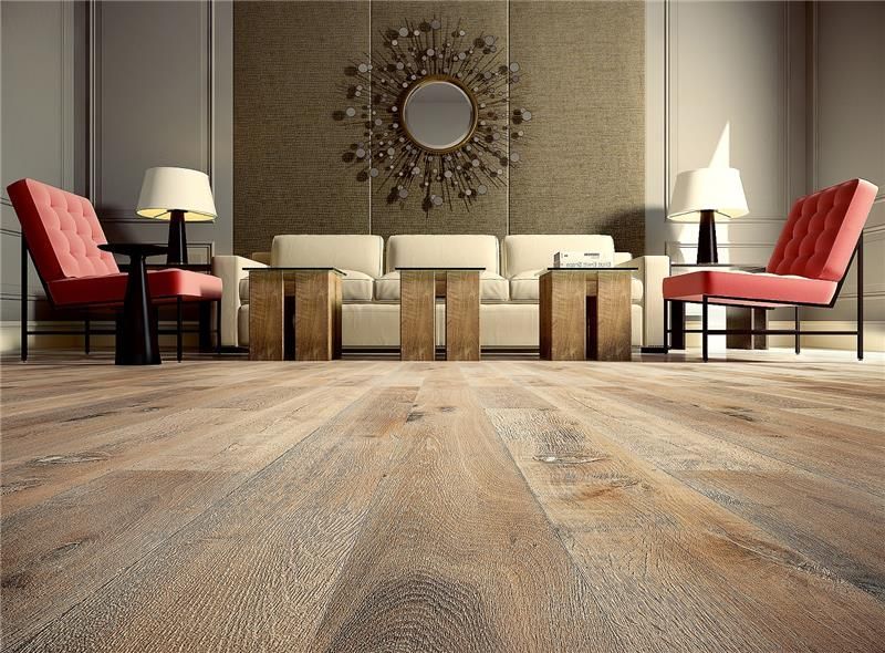 A living room with a couch and chairs and a wooden floor