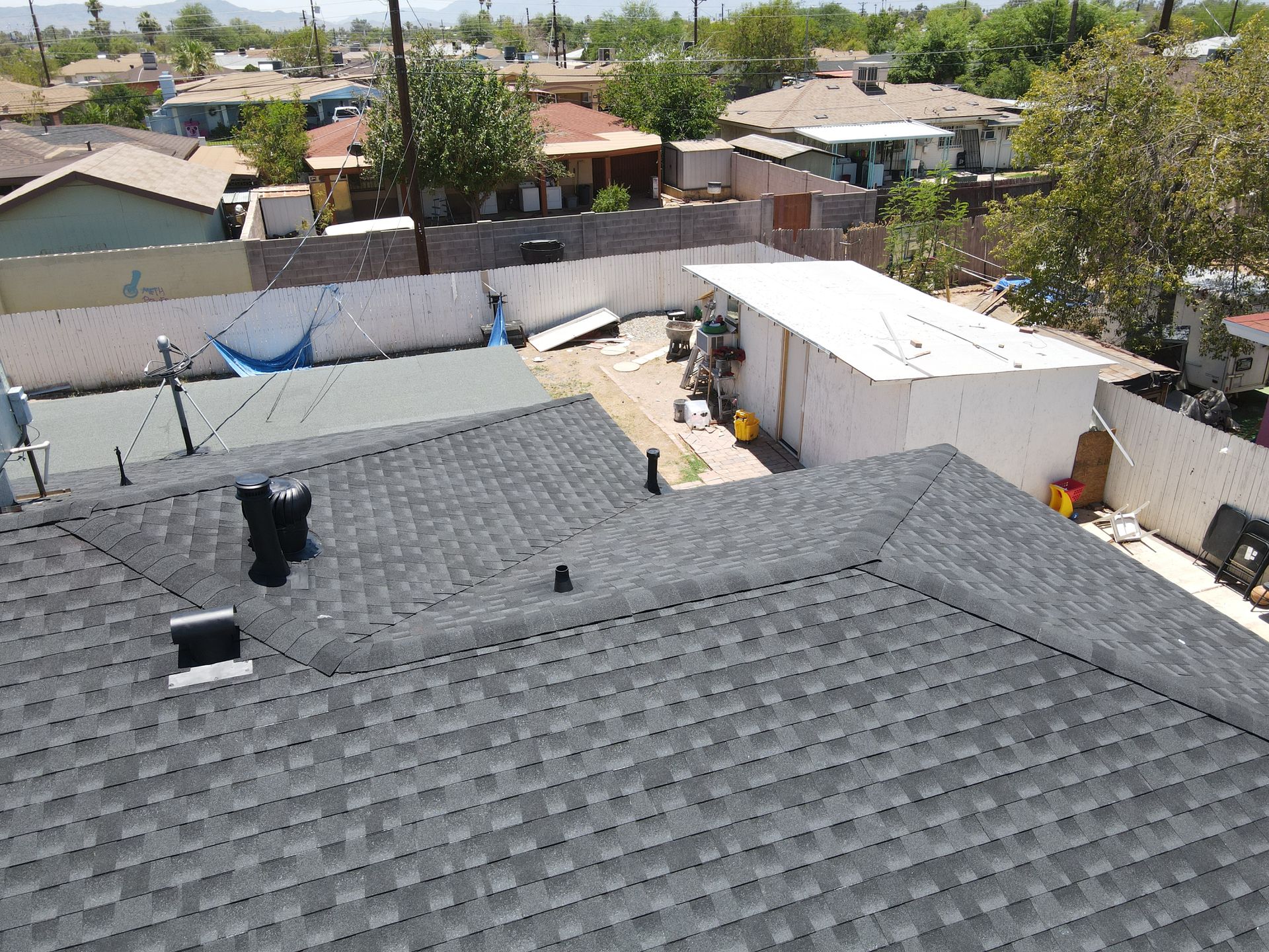 An aerial view of a roof of a house in a residential area.