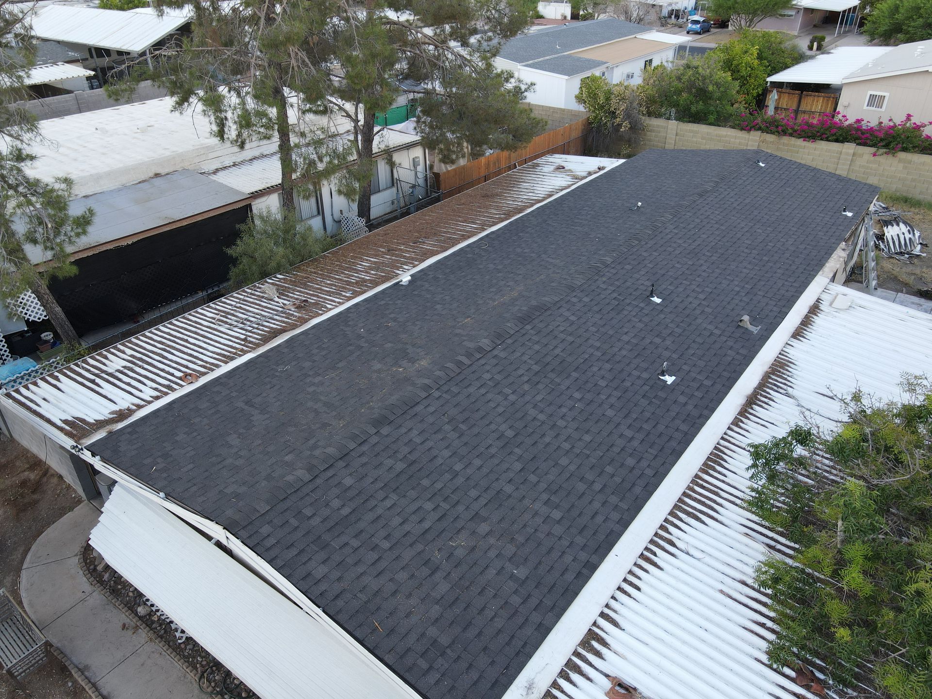 An aerial view of a house with a black roof.