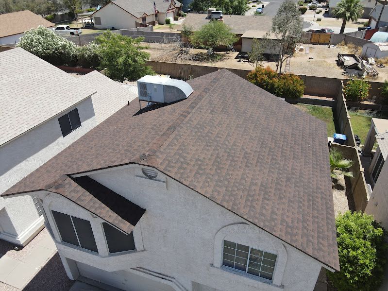 An aerial view of a house with a brown roof.
