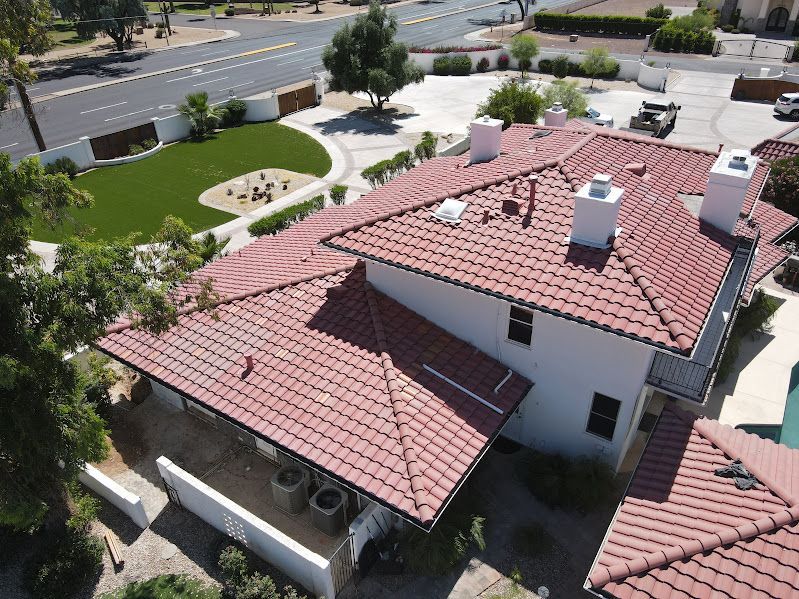 An aerial view of a house with a red tile roof.