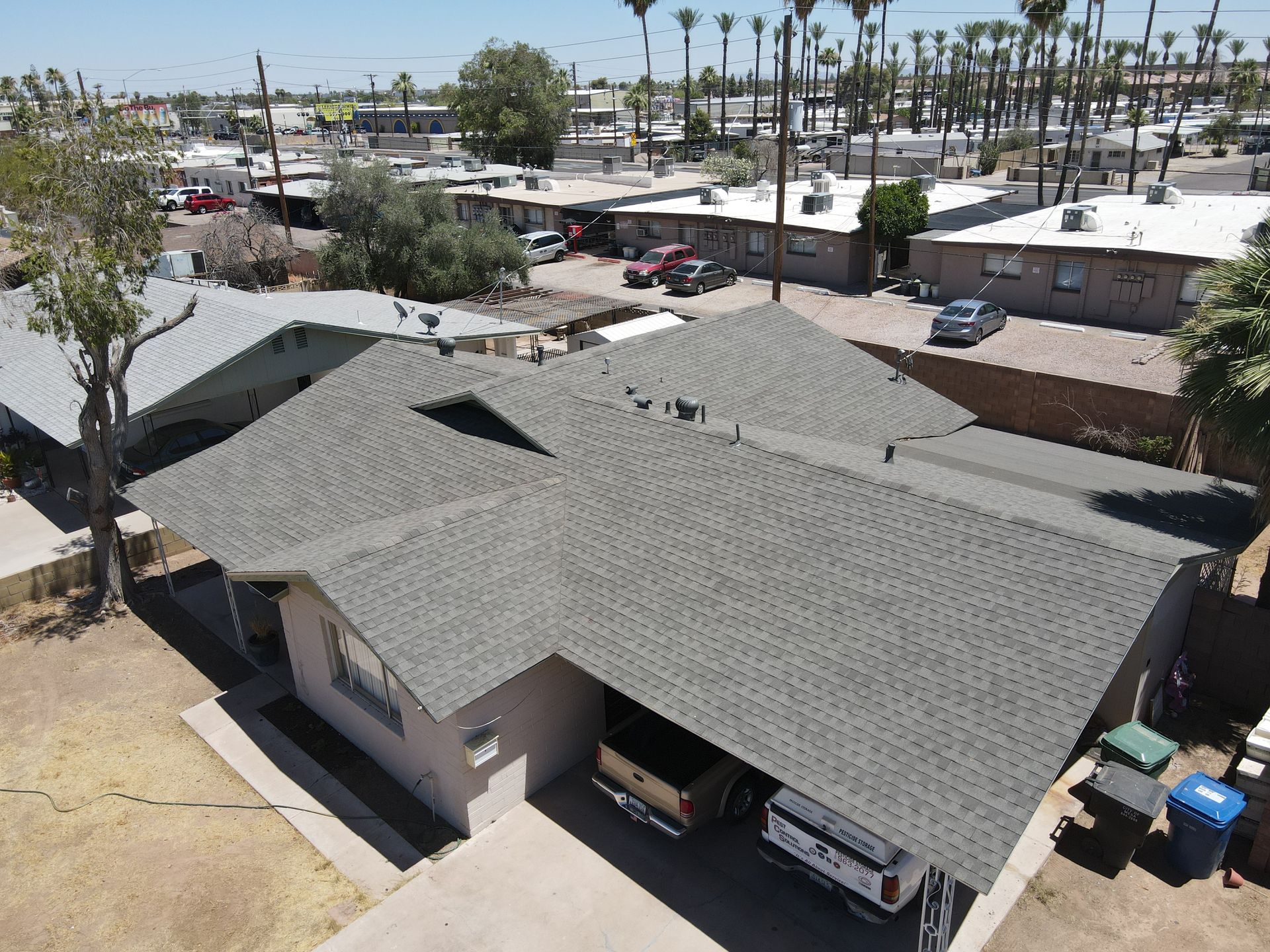 An aerial view of a house with a gray roof.