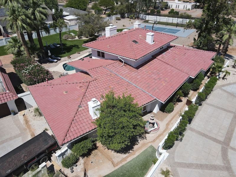 An aerial view of a house with a red tile roof.